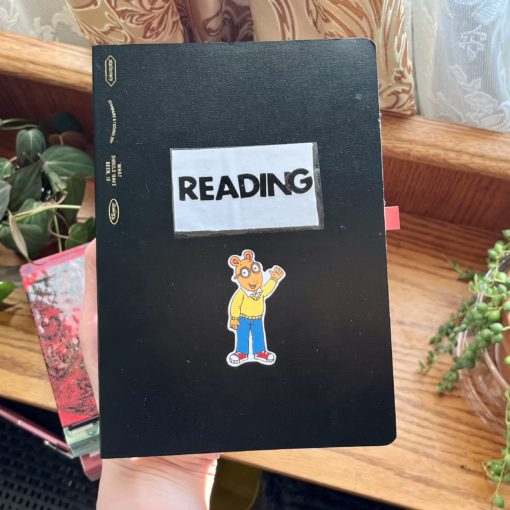 Reading journal with arthur sticker on it