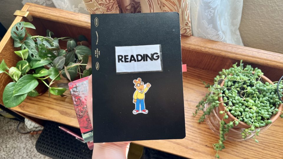 Reading journal with arthur sticker on it