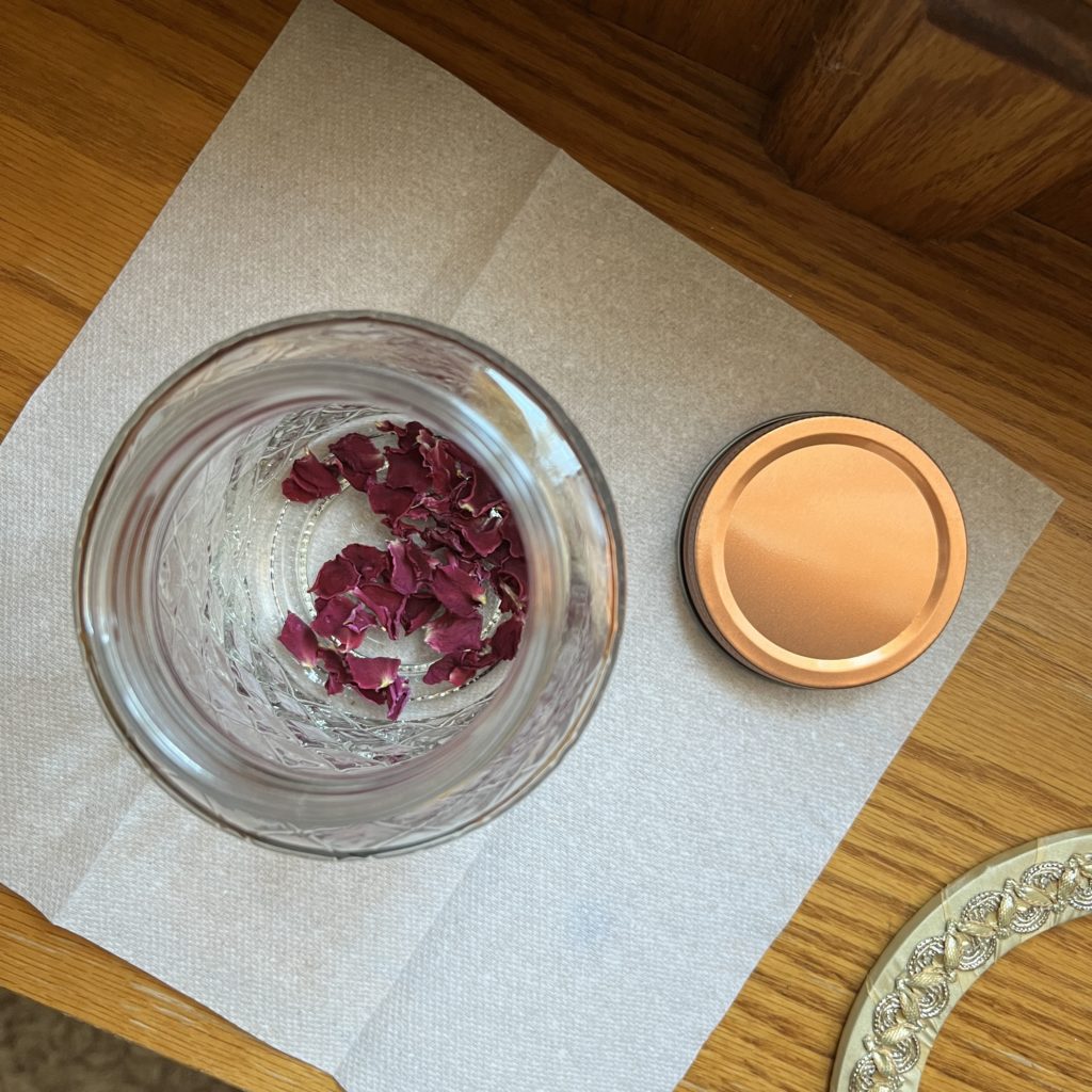 Bird's eye view of dried rose petals in a jar